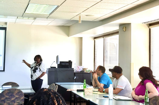 A group watching a presentation from the chief diversity officer