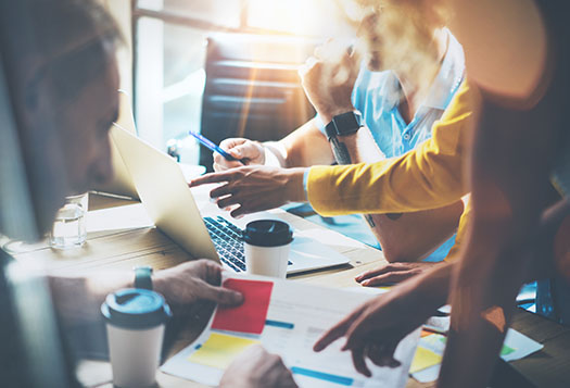 A group working together at a desk.