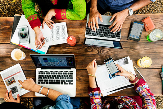 a group gathered around a table writing together