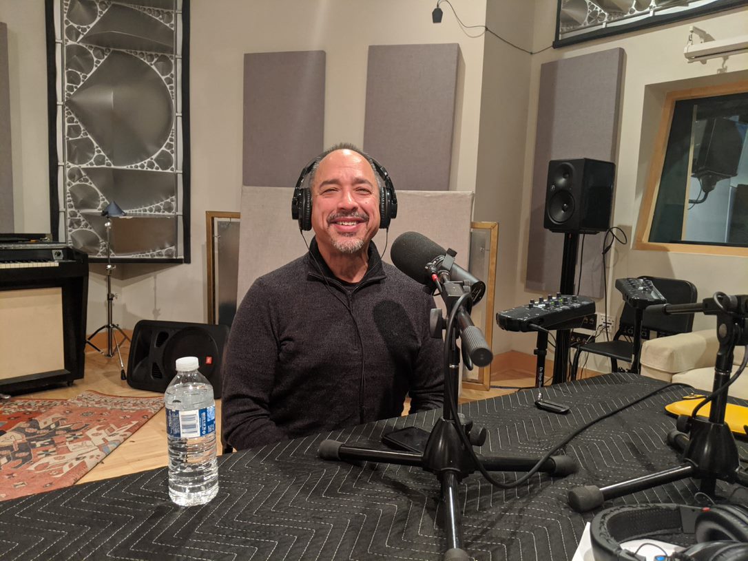 Ricardo Villarosa sitting in front of a microphone while wearing headphones