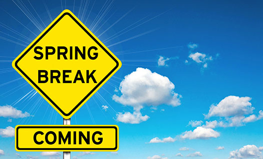 a road sign says Spring Break Coming