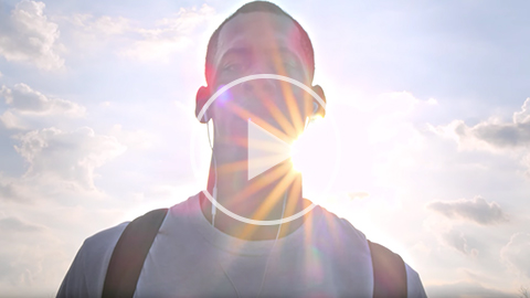 video still of a student with the sun shining behind him and peeking over his left shoulder